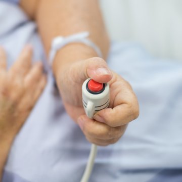 greatcall medical alert system hand pushing red emergency button